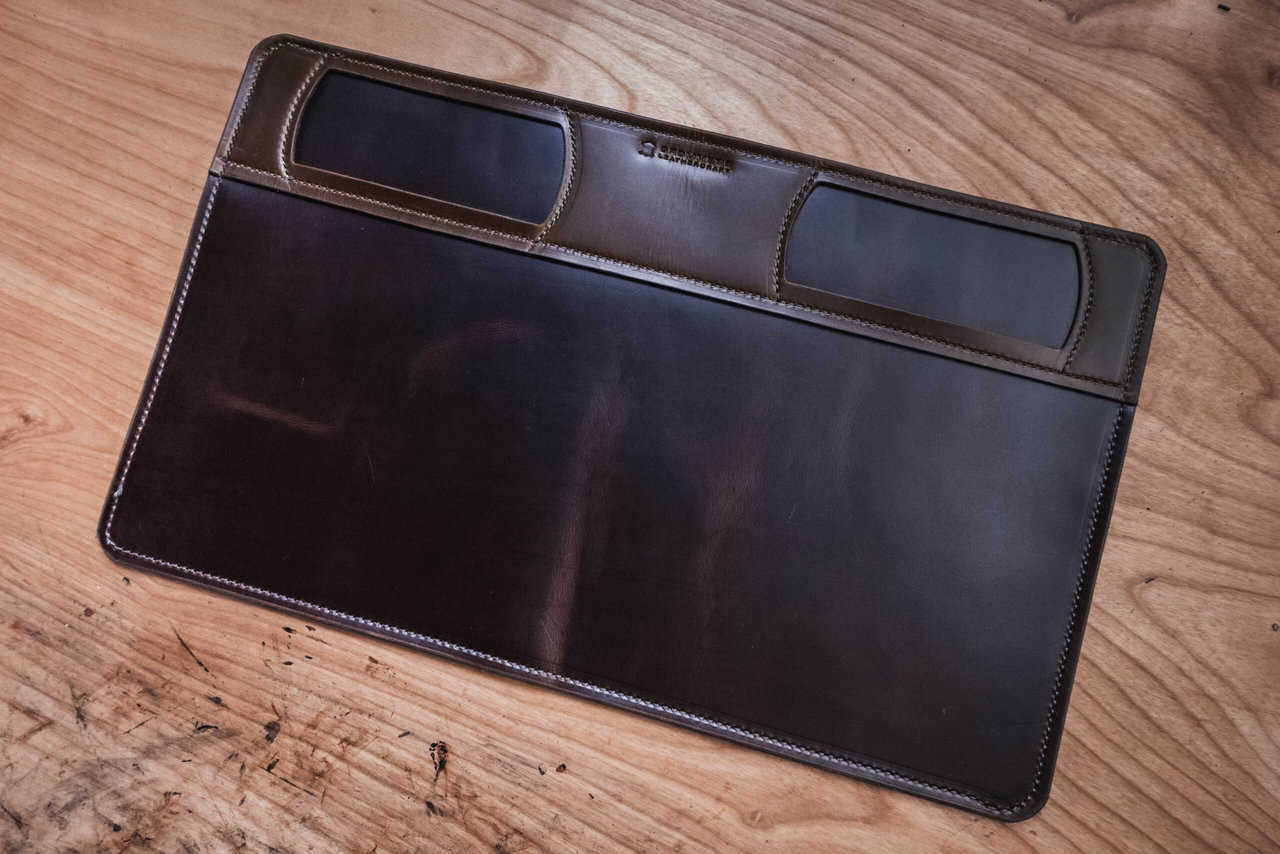 a brown leather mat on a wooden table