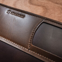 a brown leather mat on a wooden table