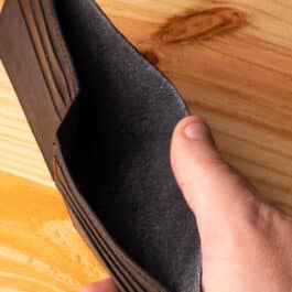 A leather wallet sitting on a wooden table