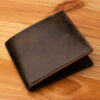 A leather wallet sitting on a wooden table
