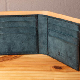 A leather wallet sitting on a wooden table