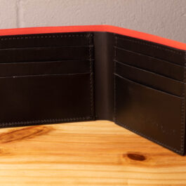A leather wallet sitting on a wooden table