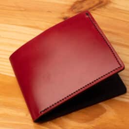 A leather wallet sitting on a wooden table