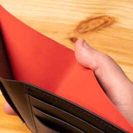 A leather wallet sitting on a wooden table