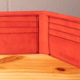 A leather wallet sitting on a wooden table