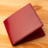 A leather wallet sitting on a wooden table