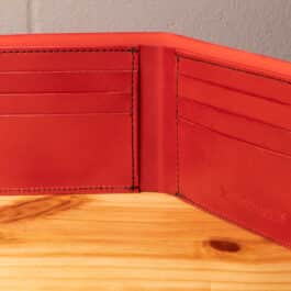 A leather wallet sitting on a wooden table