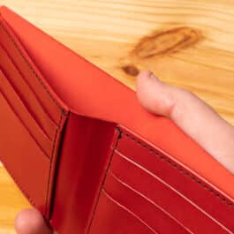 A leather wallet sitting on a wooden table
