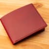 A leather wallet sitting on a wooden table