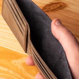 A leather wallet sitting on a wooden table