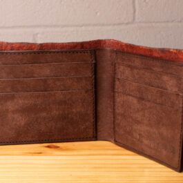 A leather wallet sitting on a wooden table