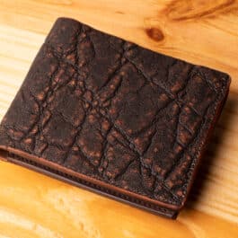 A leather wallet sitting on a wooden table
