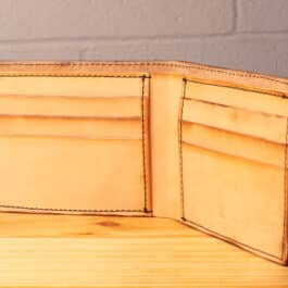 A leather wallet sitting on a wooden table