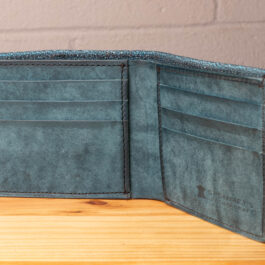 A leather wallet sitting on a wooden table