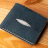 A leather wallet sitting on a wooden table