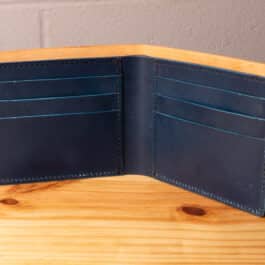 A leather wallet sitting on a wooden table