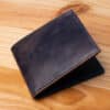 A leather wallet sitting on a wooden table