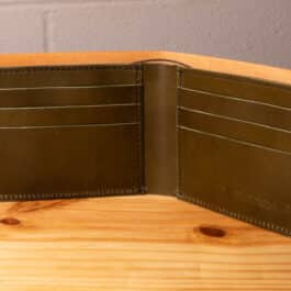 A leather wallet sitting on a wooden table