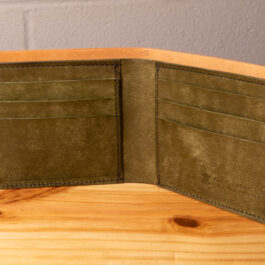 A leather wallet sitting on a wooden table