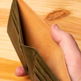 A leather wallet sitting on a wooden table