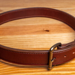 A brown Leather belt on a wooden table