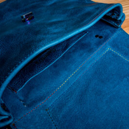 the inside of a blue leather bag