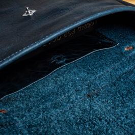 The inside of a blue leather bag