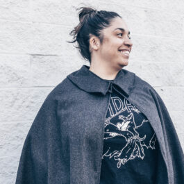 a woman wearing a wool cape