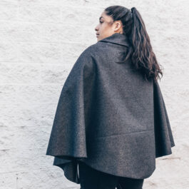 a woman wearing a wool cape
