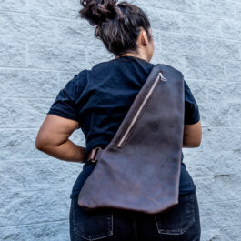 A woman with a leather sling bag on her back
