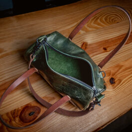 a green bison mini duffel with dark brown handles
