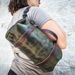 a green bison mini duffel with dark brown handles