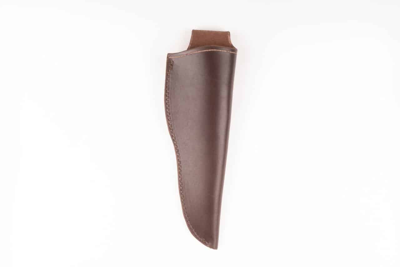 A Handmade Leather Sheath is hanging on a white wall.