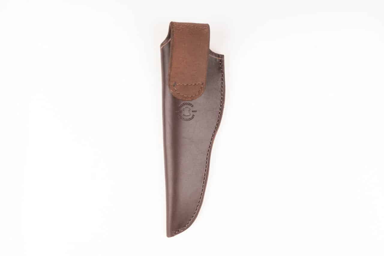 A handmade leather sheath with a brown leather handle.