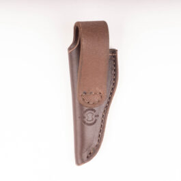A brown handmade leather sheath hanging from a wall.