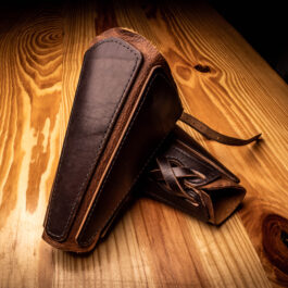 a pair of mercenary vambraces on a wooden table