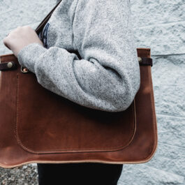 a woman holding the solvang tote in horween dublin english tan
