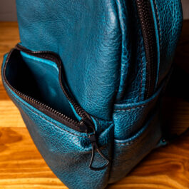 a cobalt blue mini backpack with black straps and hardware